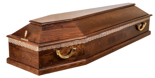 solid walnut raised lid coffin with a medium-gloss wood-grain finish, gold toned handles, lace embroidery, and metal lid-mounted escutcheons